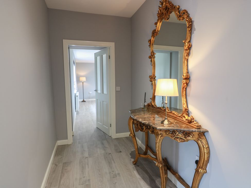 A hallway with a console table and a mirror at The Dairy in Airdrie