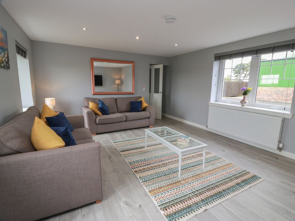 A living room with a coffee table and two sofas at The Dairy in Airdrie