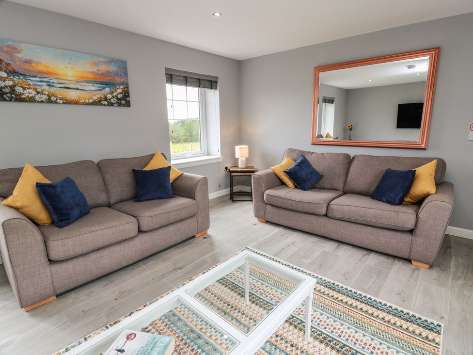 A living room with sofas and a coffee table at The Dairy in Airdrie