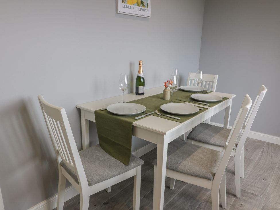 A dining room with a table set for four at The Dairy in Airdrie
