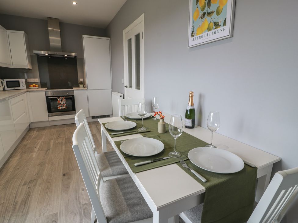 A kitchen with a dining table set up at The Dairy in Airdrie