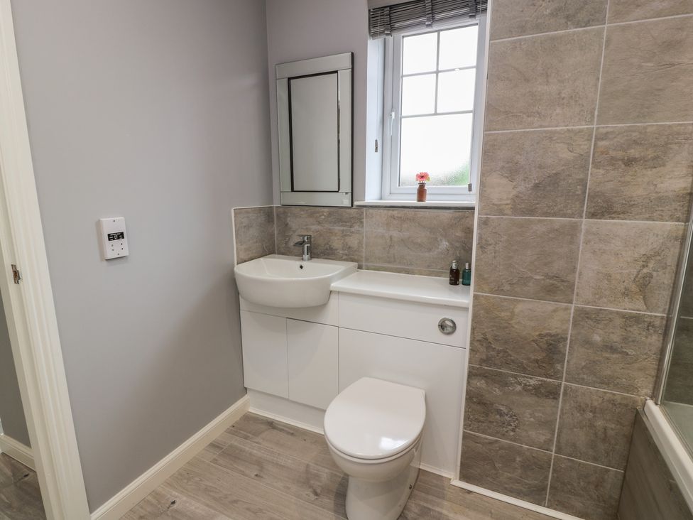 A bathroom with a sink and toilet at The Dairy in Airdrie
