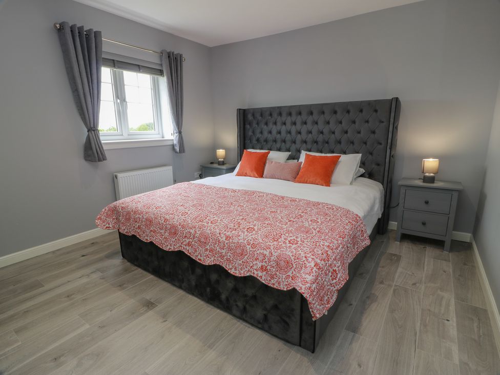 A bedroom with a double bed and nightstands at The Dairy in Airdrie