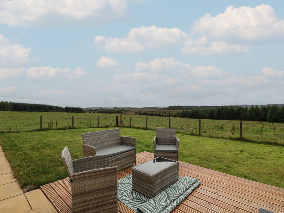 An outdoor seating area with chairs and a table at The Dairy in Airdrie