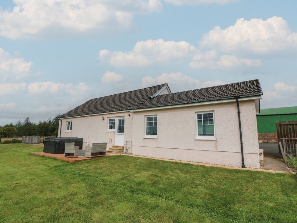 A house with a lawn and outdoor seating area at The Dairy in Airdrie