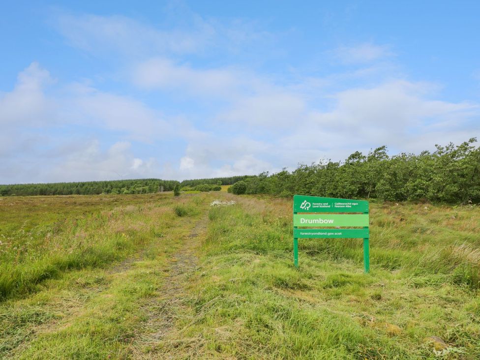 A path leading to a sign that says Drumbow in a field at The Dairy Airdrie