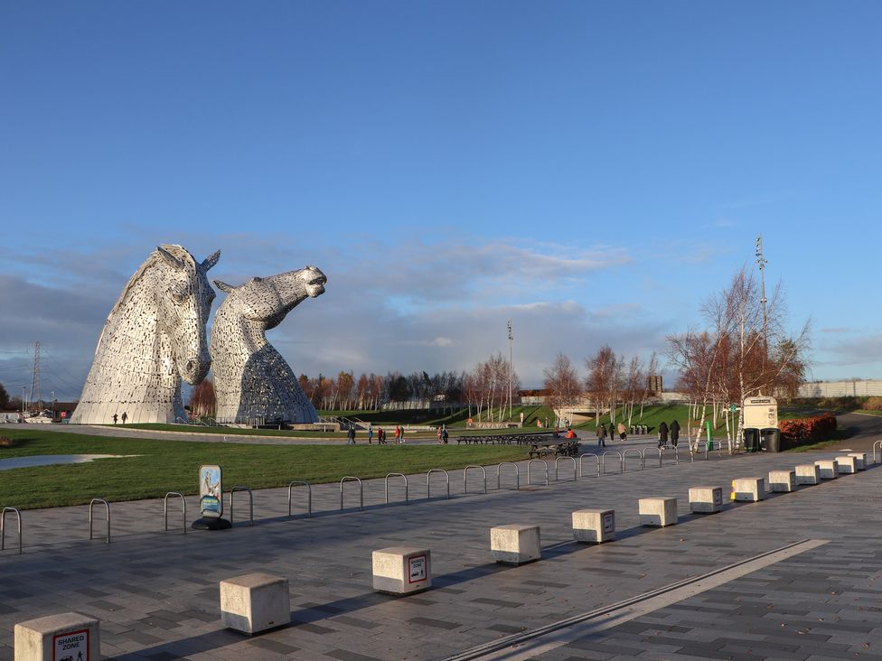 A park with horse sculptures and visitors at The Dairy in Caldercruix
