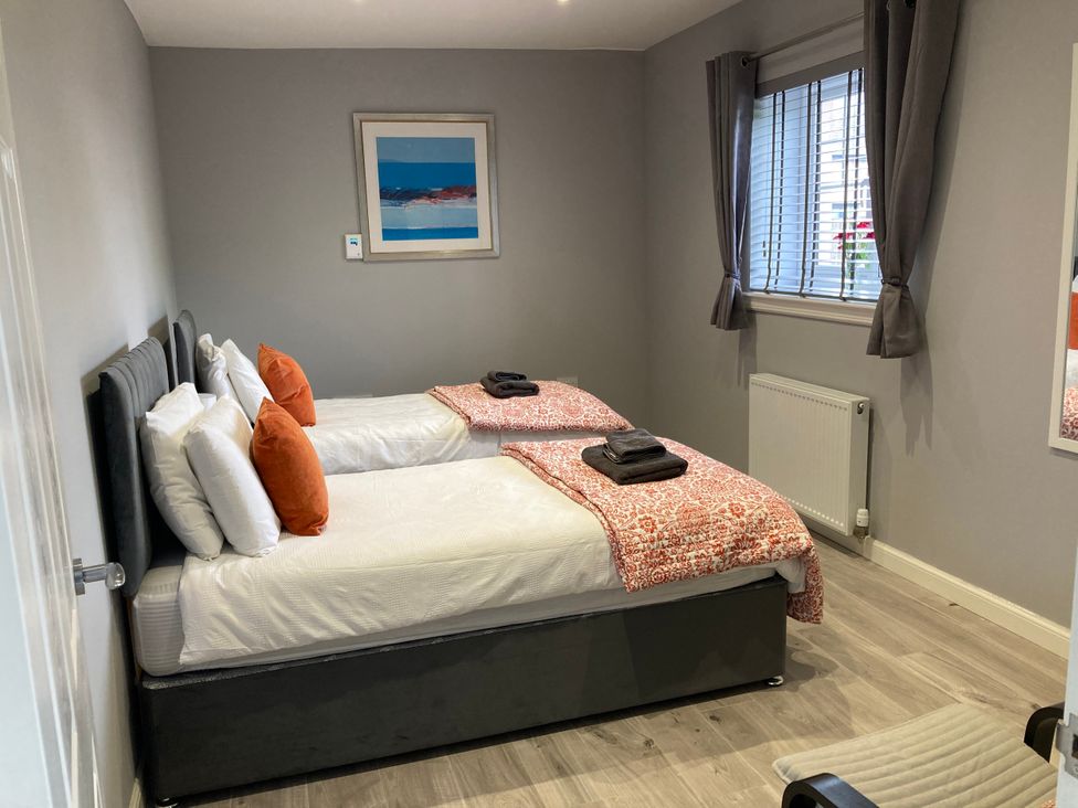 A bedroom with two beds and a window at The Dairy in Caldercruix