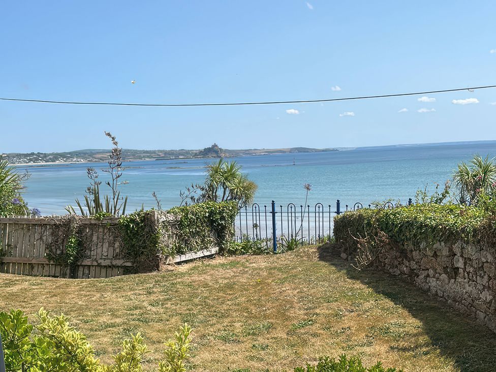 A view of the sea and garden at 1 Penrose Court in Penzance