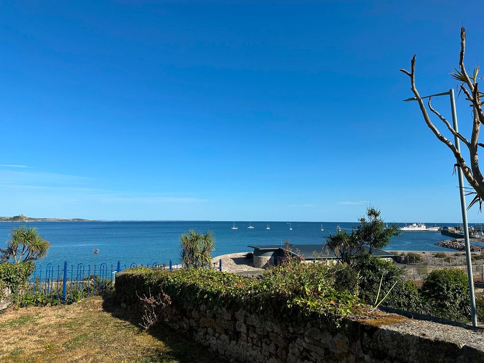 A view of the sea with sailboats and a pier at 1 Penrose Court Penzance