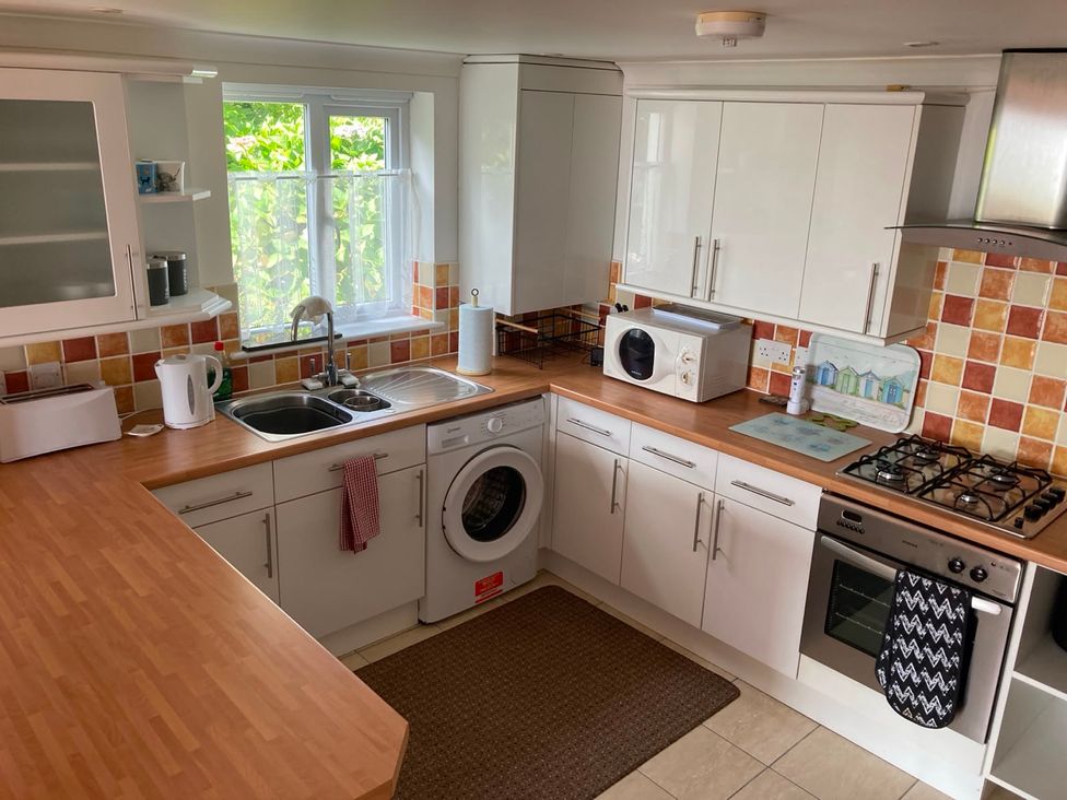 A kitchen with sink and appliances at 1 Penrose Court in Penzance