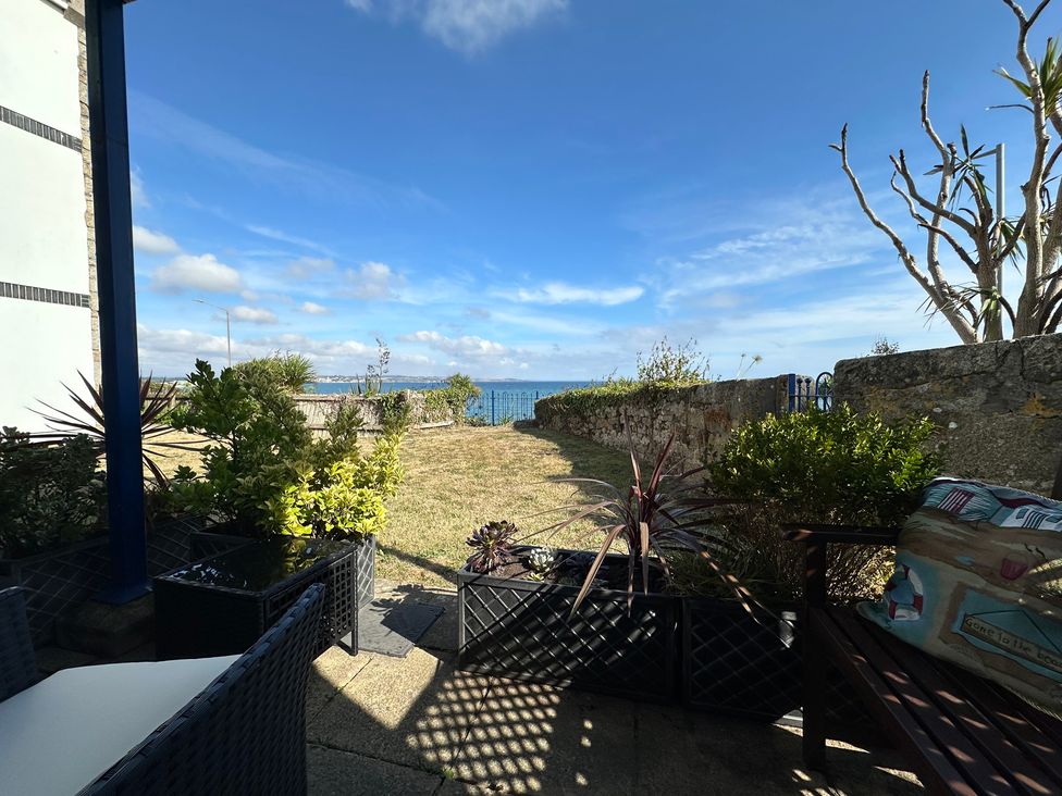 A garden view with sea and plants at Tide Watch in Penzance
