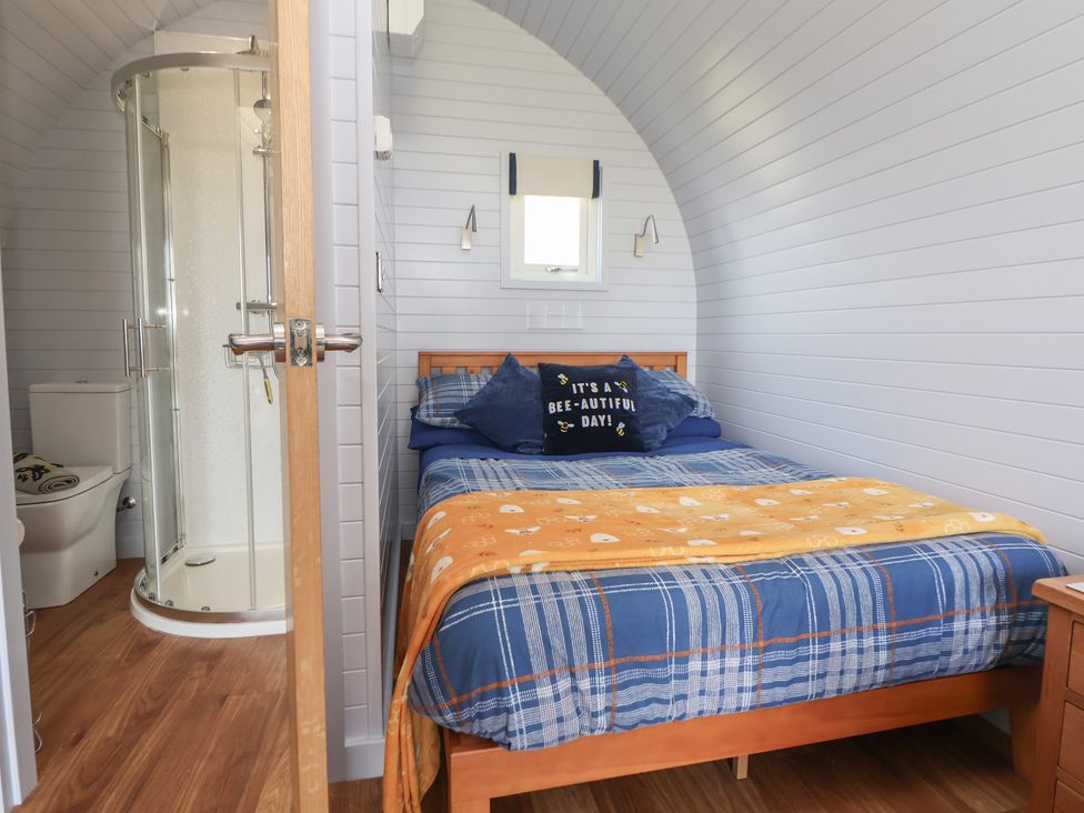 A bedroom with a bed and bathroom facilities at Honeypot Hideaways - Acacia