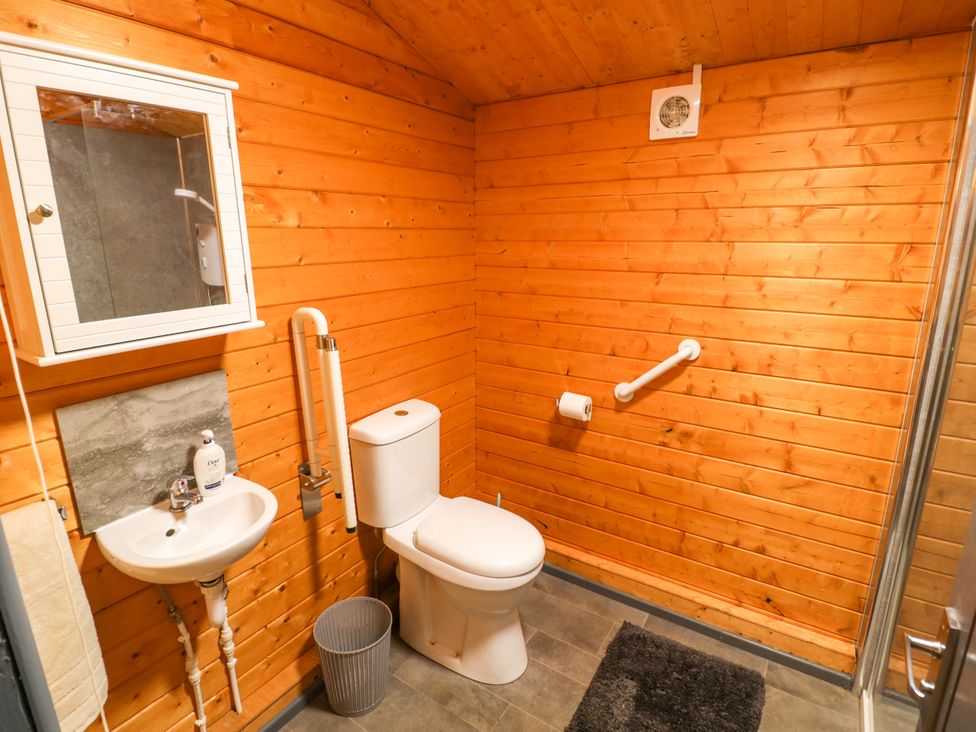 A bathroom with a toilet, sink, and shower at Stumps Cross Lodge Upper Coscombe near Winchcombe