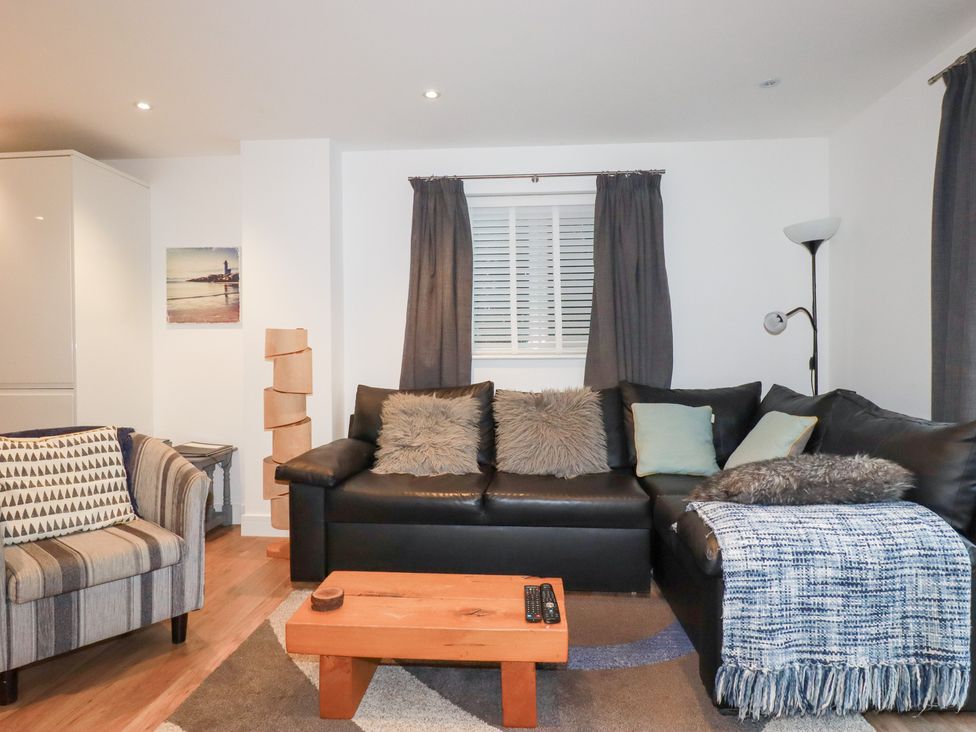 A living room with a sofa and coffee table at Fistral Palms 2