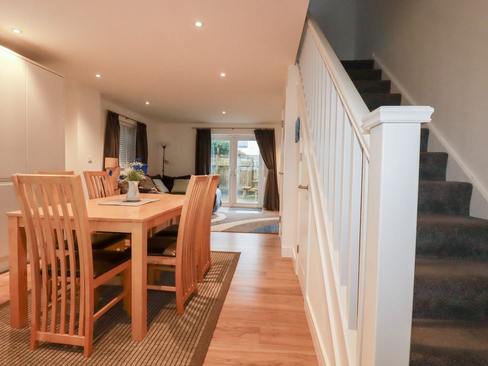 A dining room with a table and chairs at Fistral Palms 2 