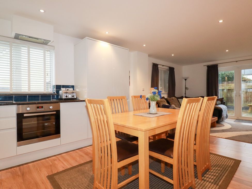 A dining room with a table and chairs at Fistral Palms 2