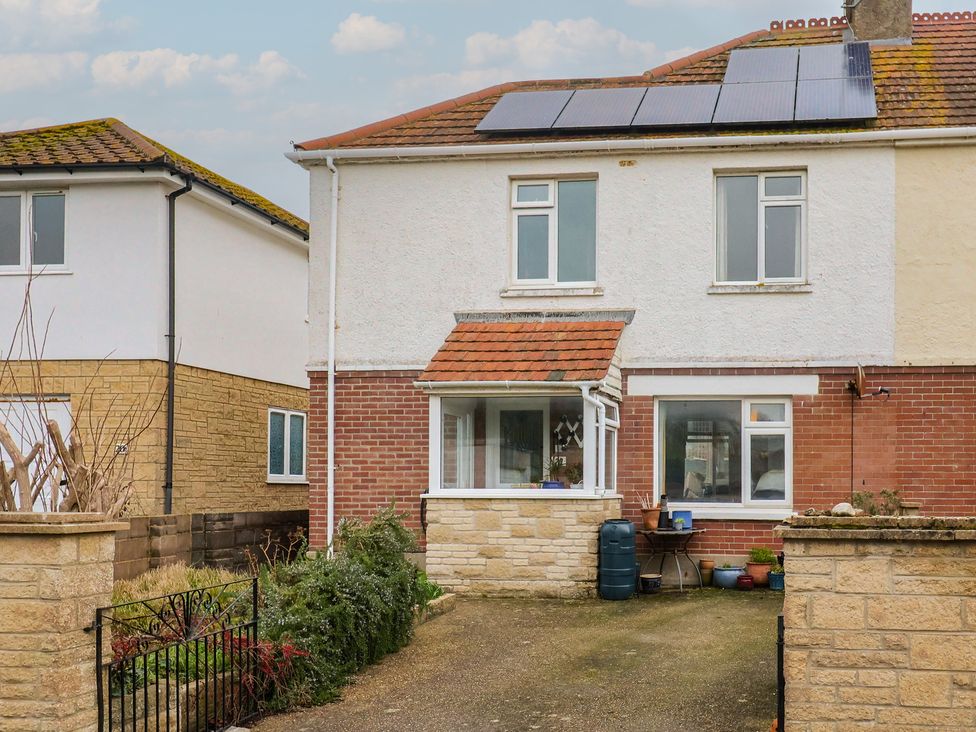 A house with solar panels on the roof at 20 Lym Close