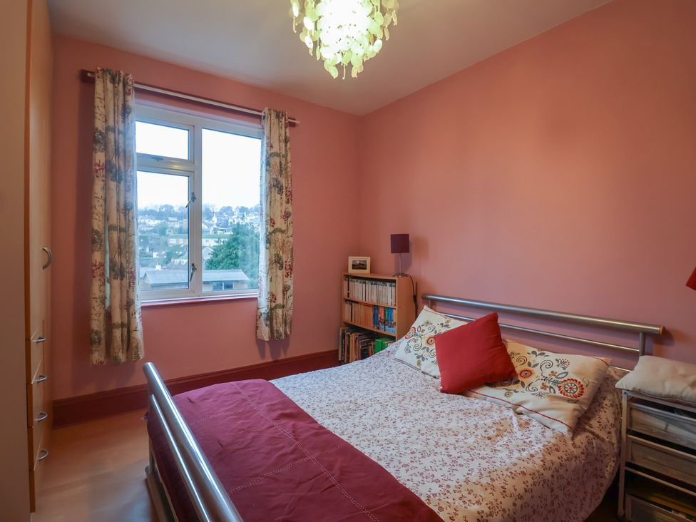 A bedroom with a bed and bookshelf at 20 Lym Close