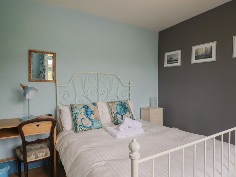 A bedroom with a bed and desk at 20 Lym Close in Lyme Regis