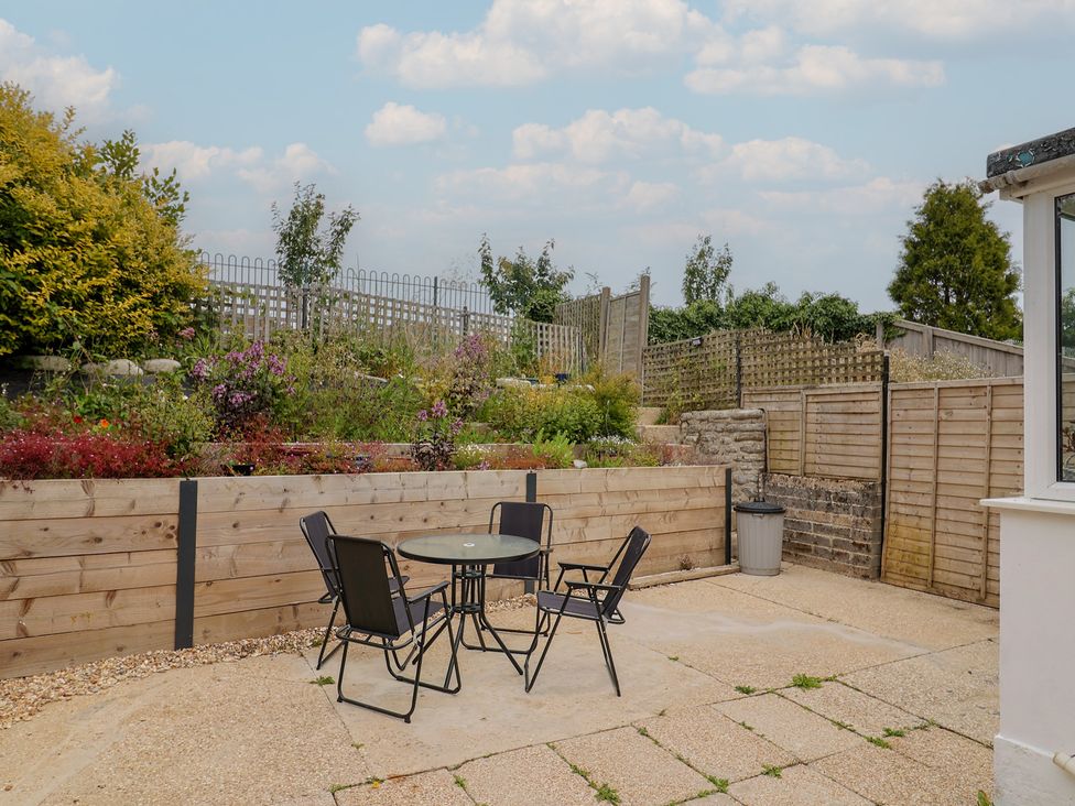 A garden with a table and chairs at 20 Lym Close Lyme Regis