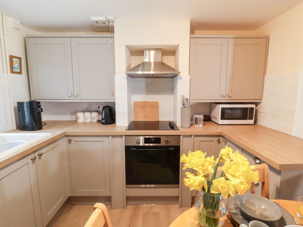A kitchen with appliances and dining table at Deben Road in Woodbridge
