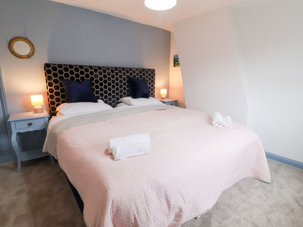 A bedroom with a bed and bedside tables at Deben Road Woodbridge