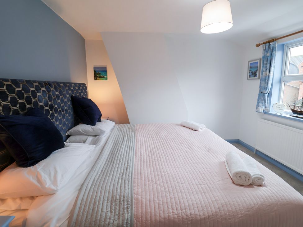 A bedroom with a large bed and pillows at Deben Road in Woodbridge