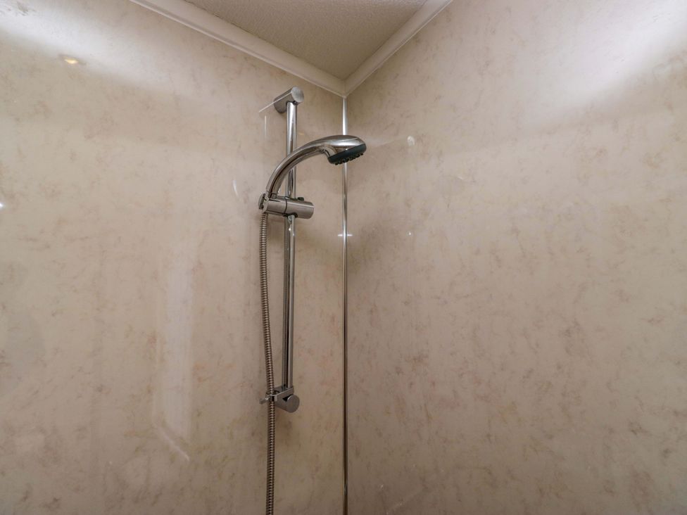 A shower with a chrome shower head at Wansfell 2 Limefitt Park near Troutbeck