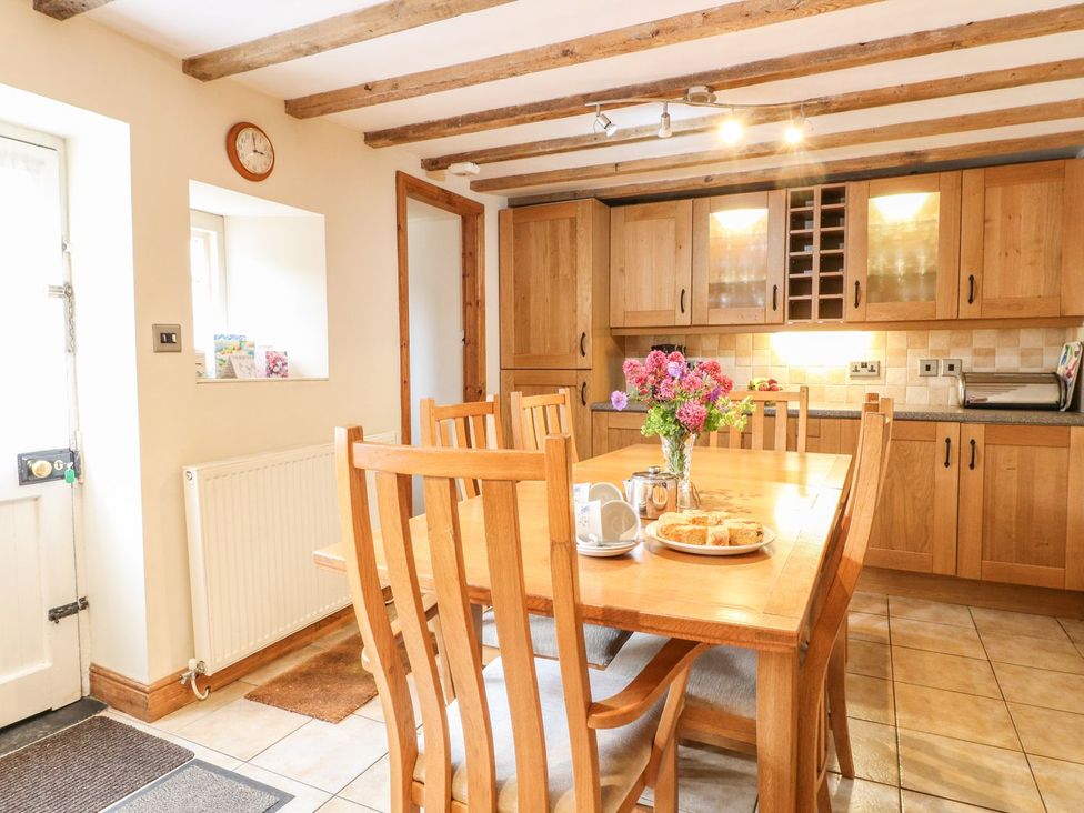 A kitchen with a dining table and chairs at Orchard View in Ashbourne