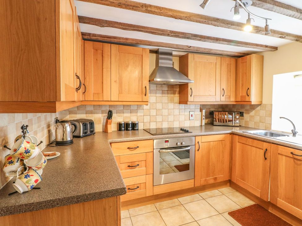 A kitchen with cabinets and appliances at Orchard View in Ashbourne