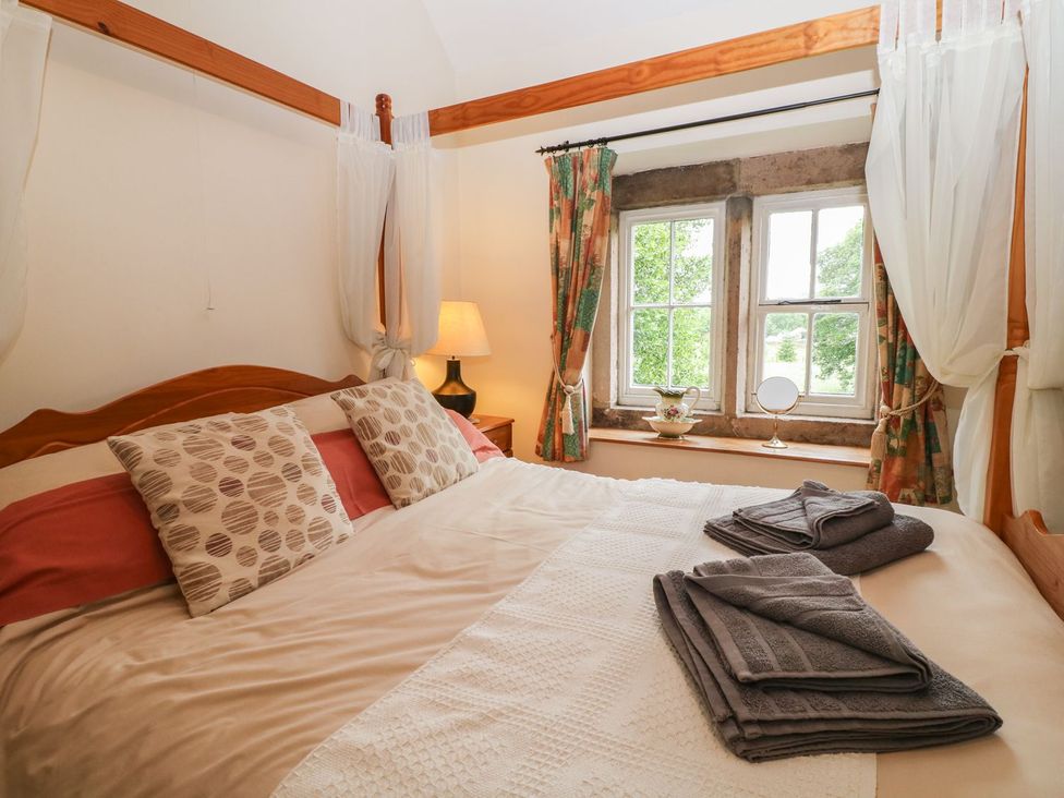 A bedroom with a bed and window at Orchard View in Ashbourne
