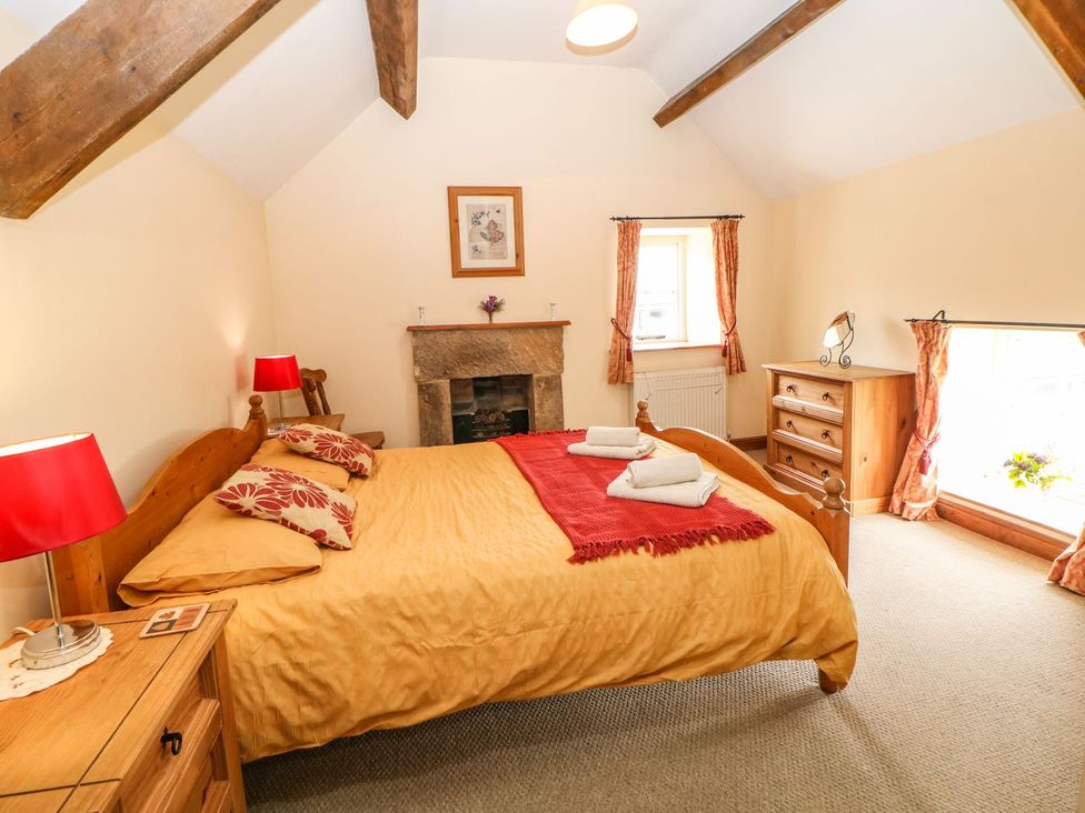 A bedroom with a bed and dresser at Orchard View in Ashbourne