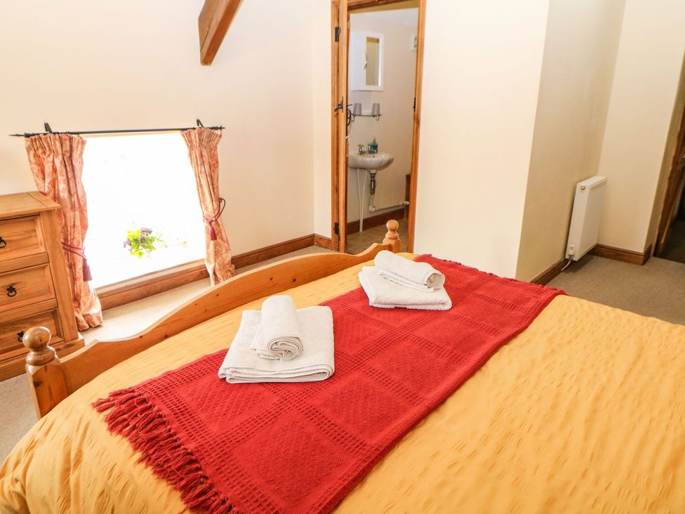 A bedroom with a bed and towels on it at Orchard View in Ashbourne
