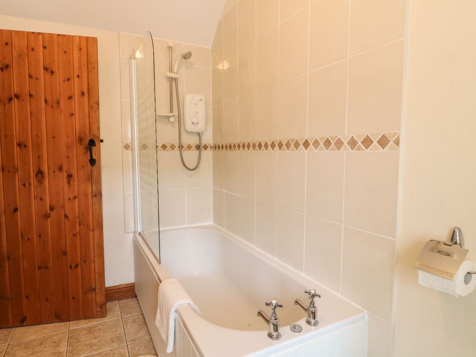 A bathroom with a bathtub and shower at Orchard View in Ashbourne