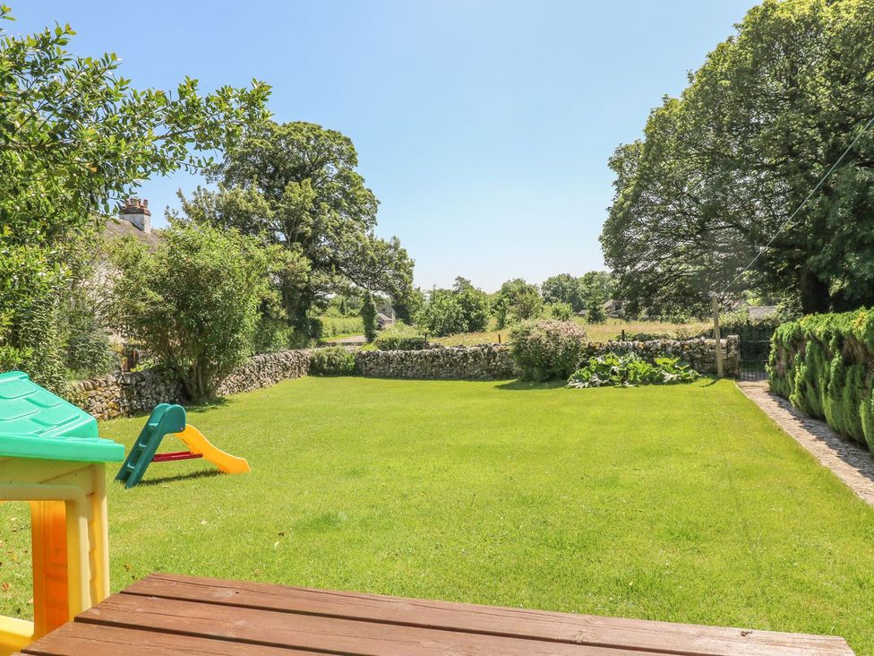 A garden with slide and stone wall at Orchard View Ashbourne