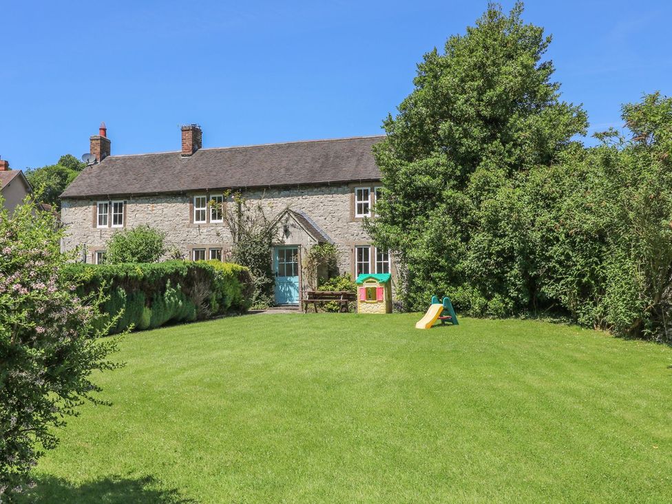 A house with a garden and play equipment at Orchard View in Ashbourne