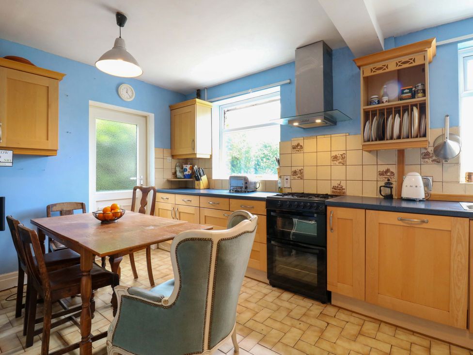 A kitchen with a table and chairs at Hillside in High Wycombe