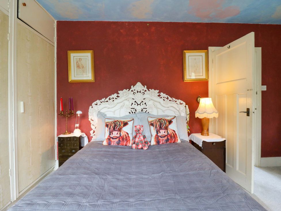 A bedroom with a bed and bedside lamp at Hillside in High Wycombe
