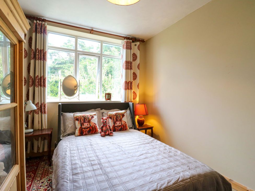 A bedroom with a bed and curtains at Hillside in High Wycombe