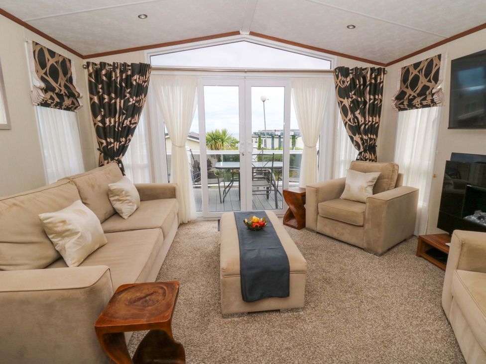 A living room with a sofa and armchairs at Ty Seren in New Quay