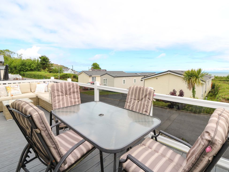 An outdoor seating area with a table and chairs at Ty Seren in New Quay