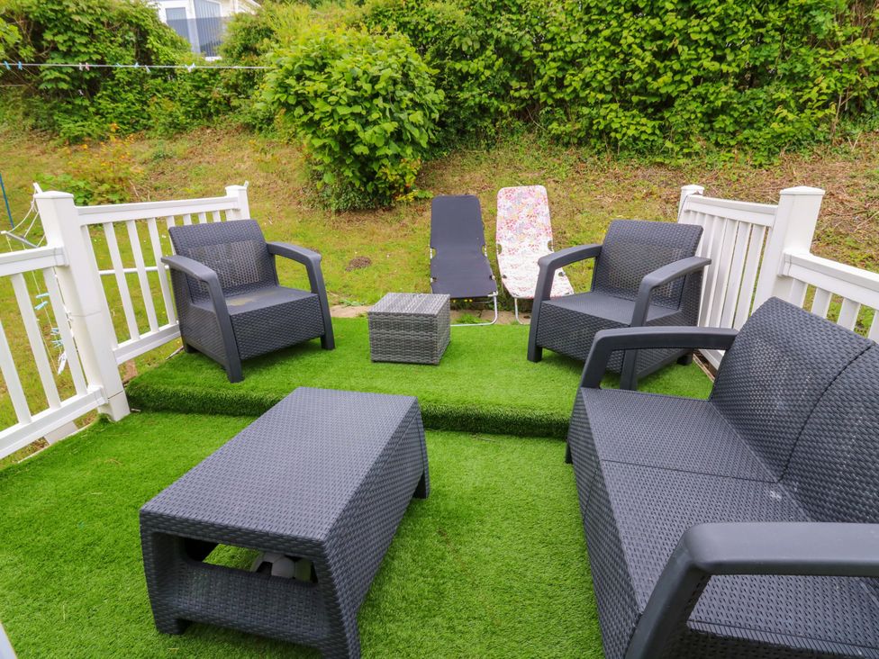 An outdoor seating area with sofas and a table at Ty Seren in New Quay
