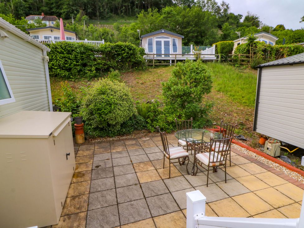 An outdoor patio with a table and chairs at Ty Seren in New Quay