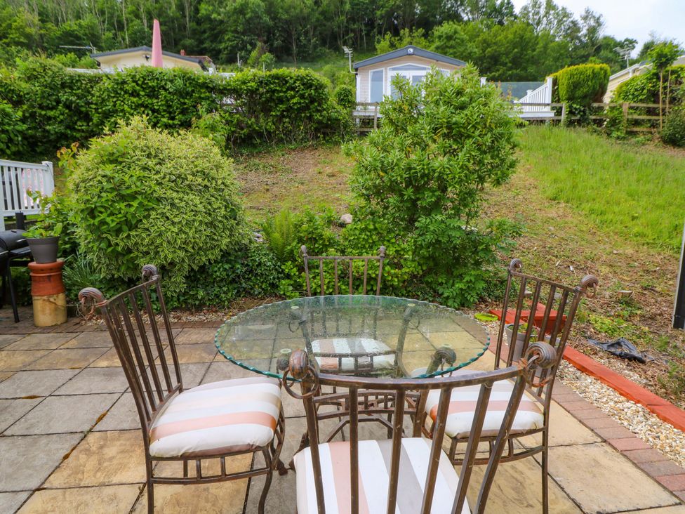 A table with chairs in an outdoor area at Ty Seren in New Quay
