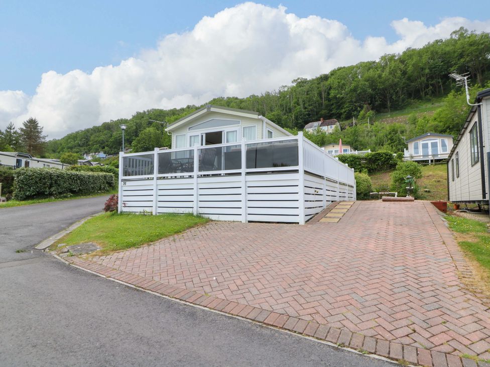 A holiday home with a deck and paved area at Ty Seren in New Quay