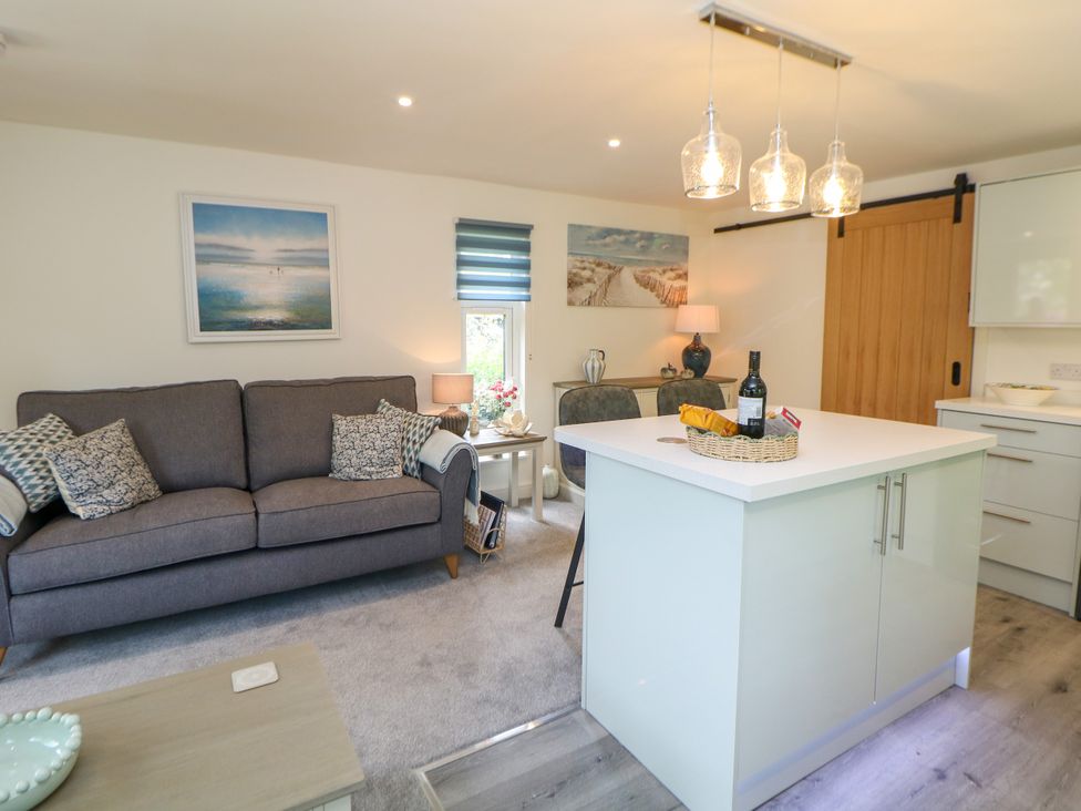 A living room with a sofa and kitchen island at Stoney Rock Lodge 