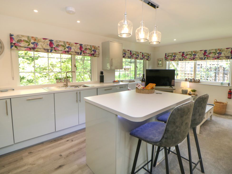 A kitchen with a countertop and stools at Stoney Rock Lodge