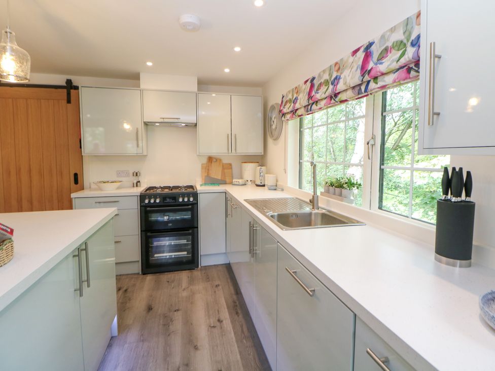 A kitchen with cabinets and a sink at Stoney Rock Lodge 