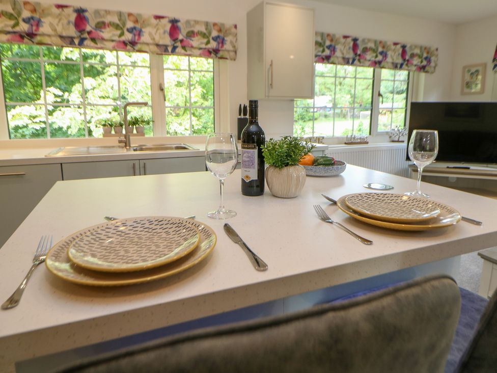 A kitchen with a dining table set for two at Stoney Rock Lodge